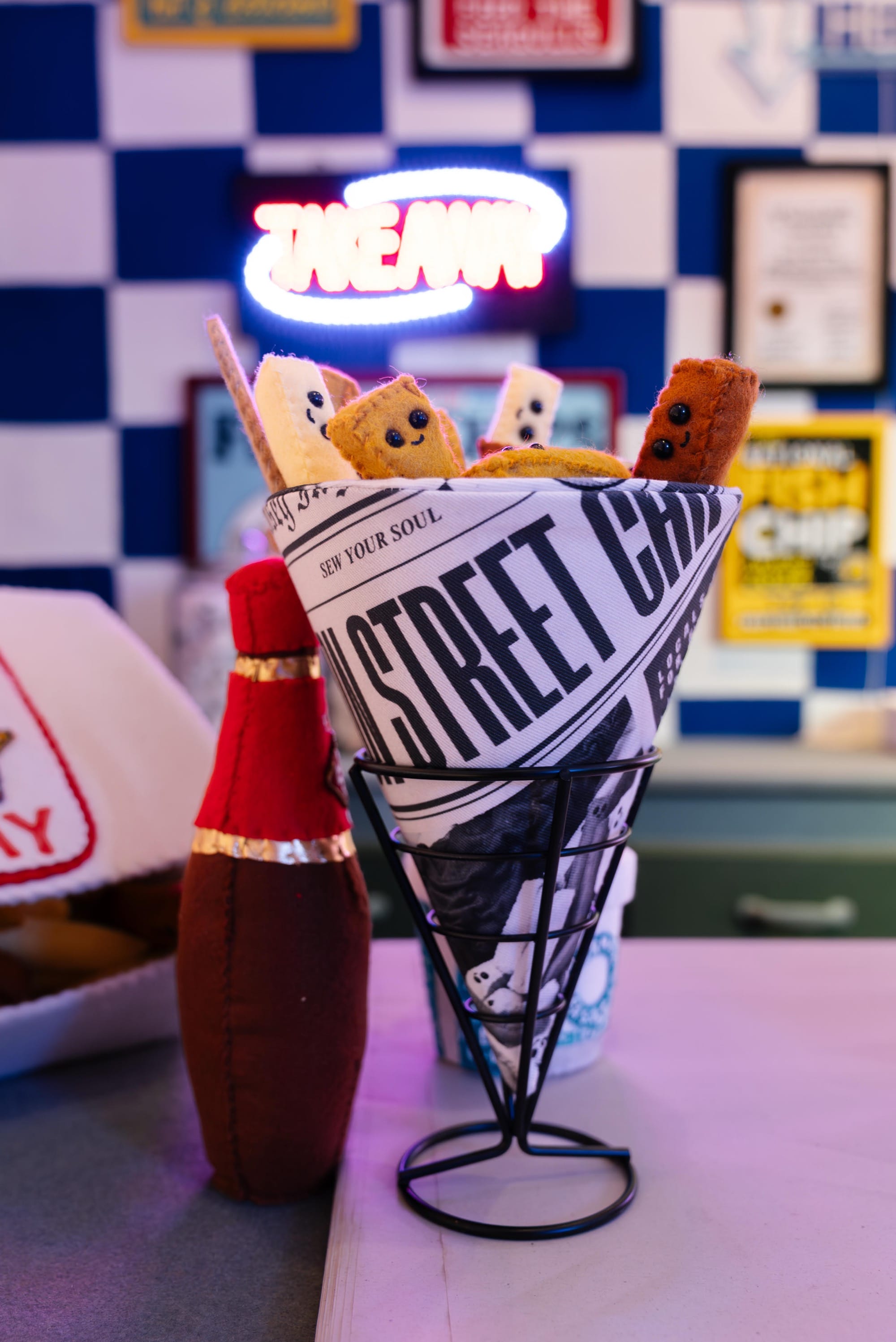 a newsprint cone full of chips in an art installation made entirely of felt