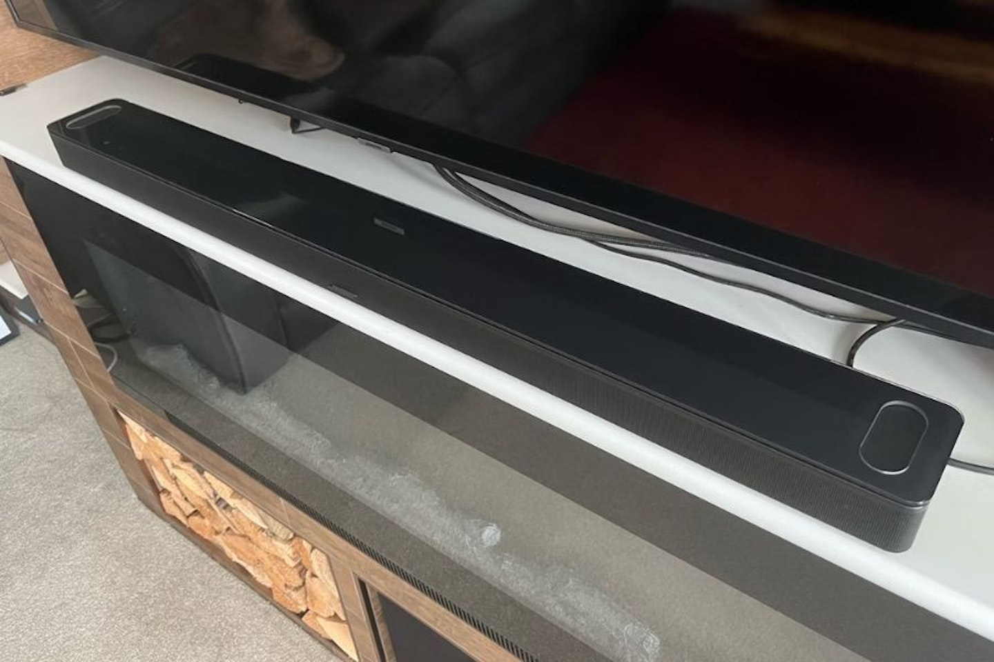 Bose Smart Ultra Soundbar in a lounge below a TV - the best overall Bose soundbar