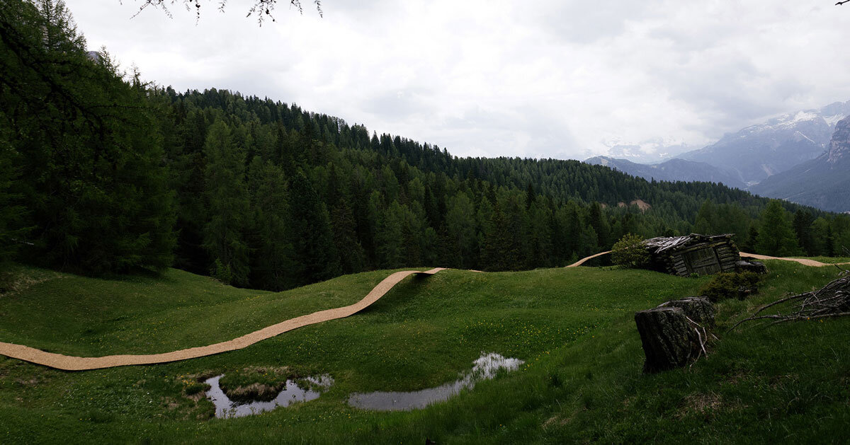 hay bales unroll into trace of land installation across alpine terrain
